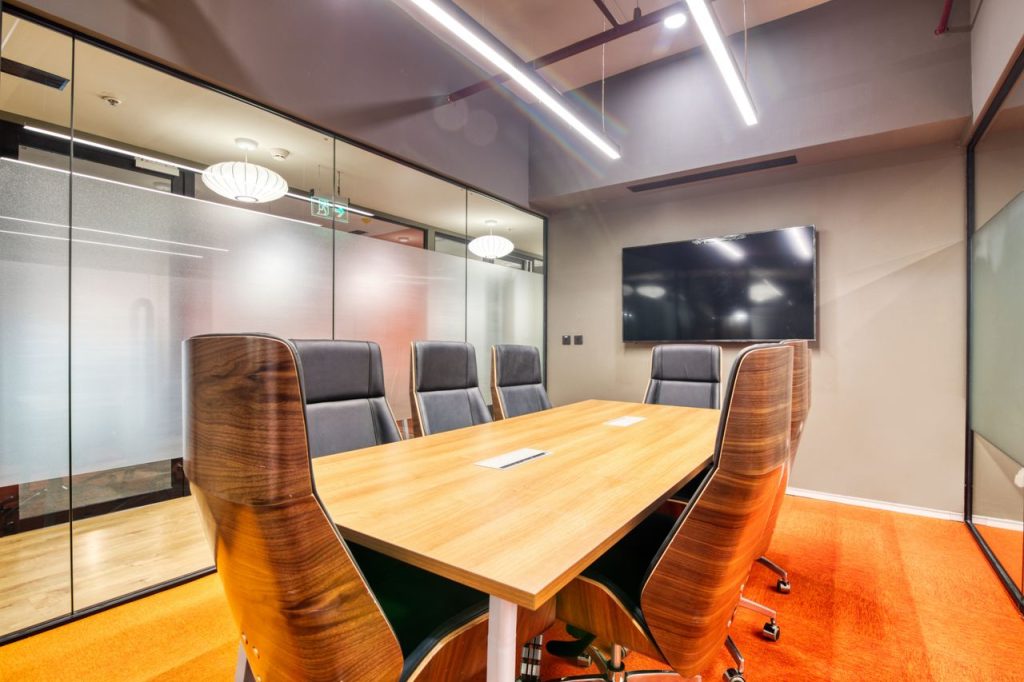 Sophisticated conference room with sleek furniture and glass walls. Ideal for business meetings.